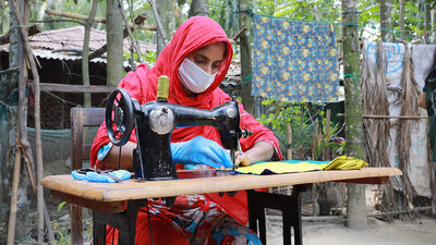 During the covid-19 pandemic, in Cox's Bazar, Bangladesh, WFP engaged with women from the host community and Rohingya refugees through its livelihood program to make masks that were distributed by local government and humanitarian agencies giving them a monthly stipend, marketable job training and financial literacy, and a scholarship to start a business. WFP/Nalifa Mehelin