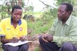 A farmer collects money from a group member. Photo: WFP/Victoria Kamara