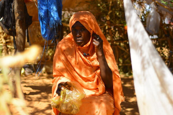 Photo: WFP/Mohamed Galal. A family that doesn't have money or anything and they don't have what to eat, they eat the residuals from the production of groundnut oil called Ombaz. Sudan, North Darfur, Zamzam Camp.  