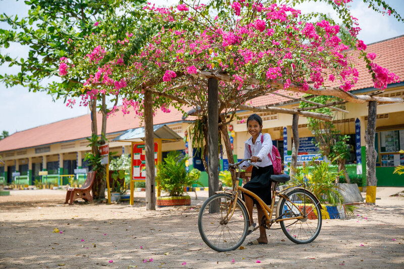 a school girl is riding bicycle