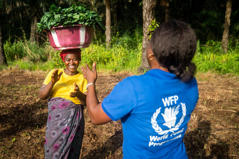 a WFP staff is laughing with a beneficiary