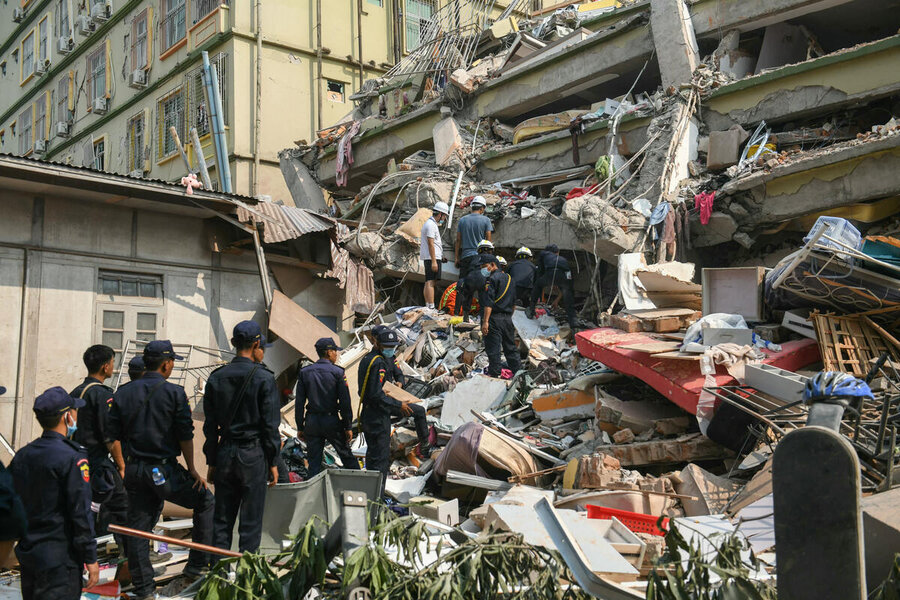 A line of rescue workers in Mandalay ascends rubble to find people in destroyed condomininium