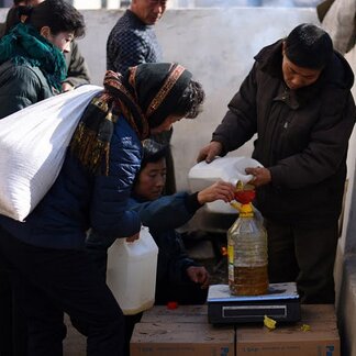 People receiving food rations provided by WFP in Songchon County, South Pyongan Province, DPR Korea