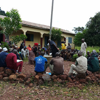 People sitting in a circle receiving support from WFP