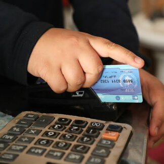 WFP enhances refugees' purchasing power and food choice through the cash assistance programme. Photo: WFP / Neda Mobarra.