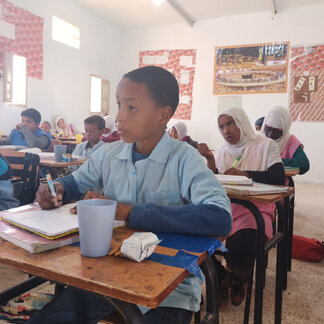 Refugee schoolboy about to enjoy his school meal. Photo: WFP/Abderezak Bouhaceine