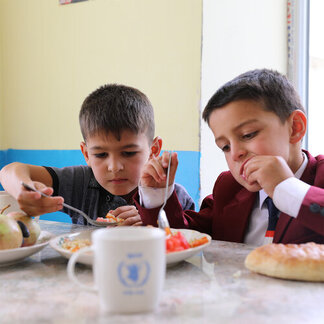 two children are having their school meals