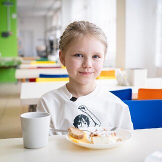 Child eating healthy and nutritious school meals