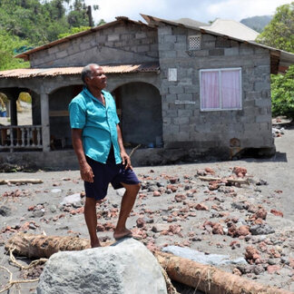 a man in front of his house