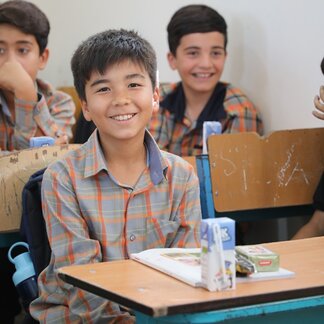 WFP distributes School Snacks amongst refugee students and their teachers in 20 settlements across the country. Photo: WFP / Neda Mobarra.
