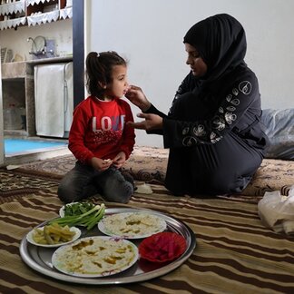 Rima a mother of four children prepares traditional dish called Batoursh using WFP assistance card to buy fresh food items.  Photo: © WFP/Hussam Al Saleh.