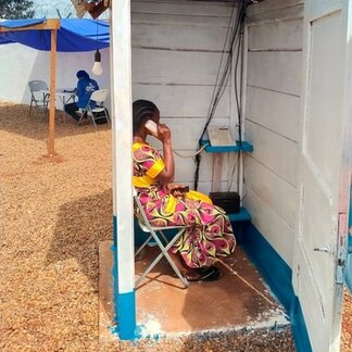 Woman making a phone call in a phone booth